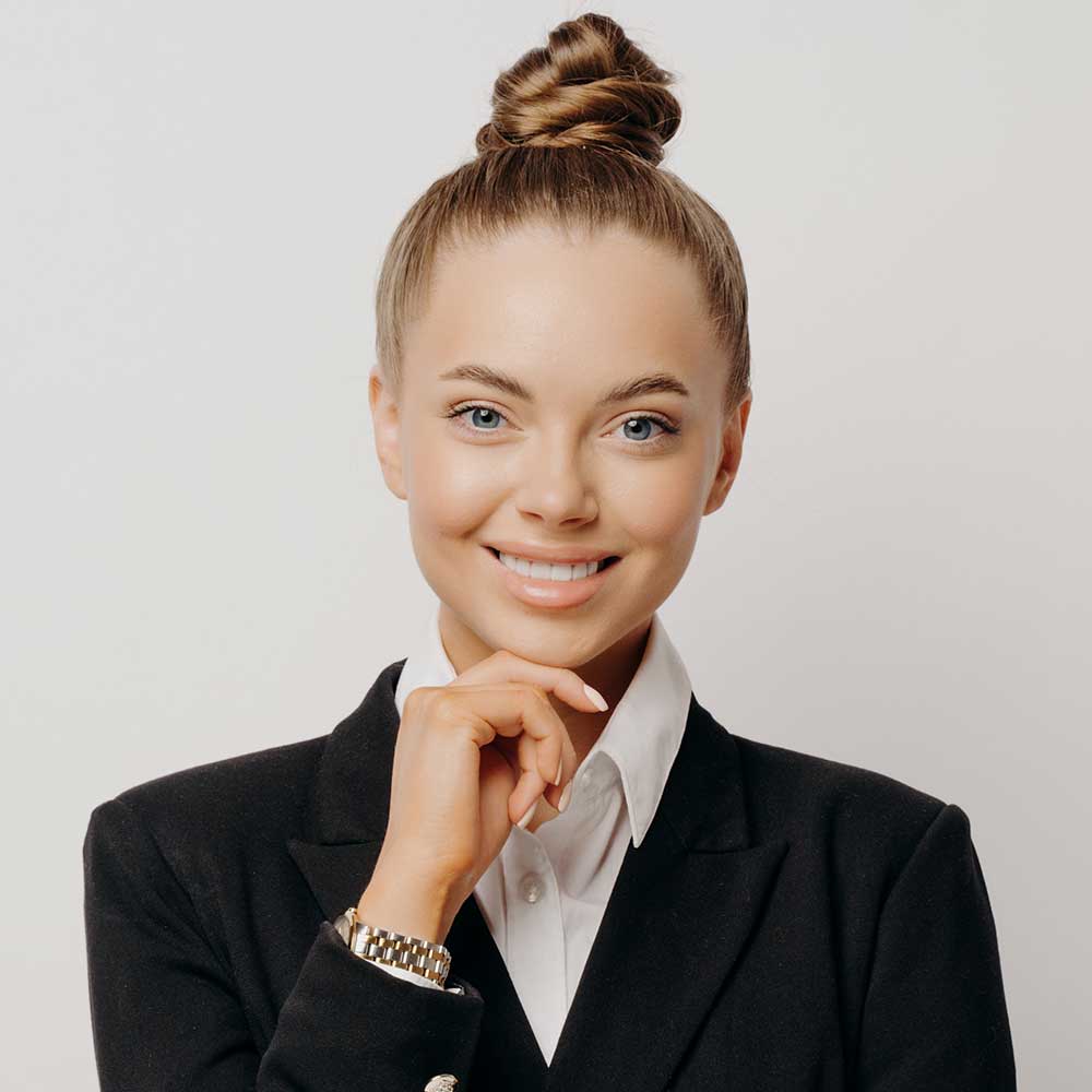 happy female office worker with hand on chin RRP5GH2.jpg